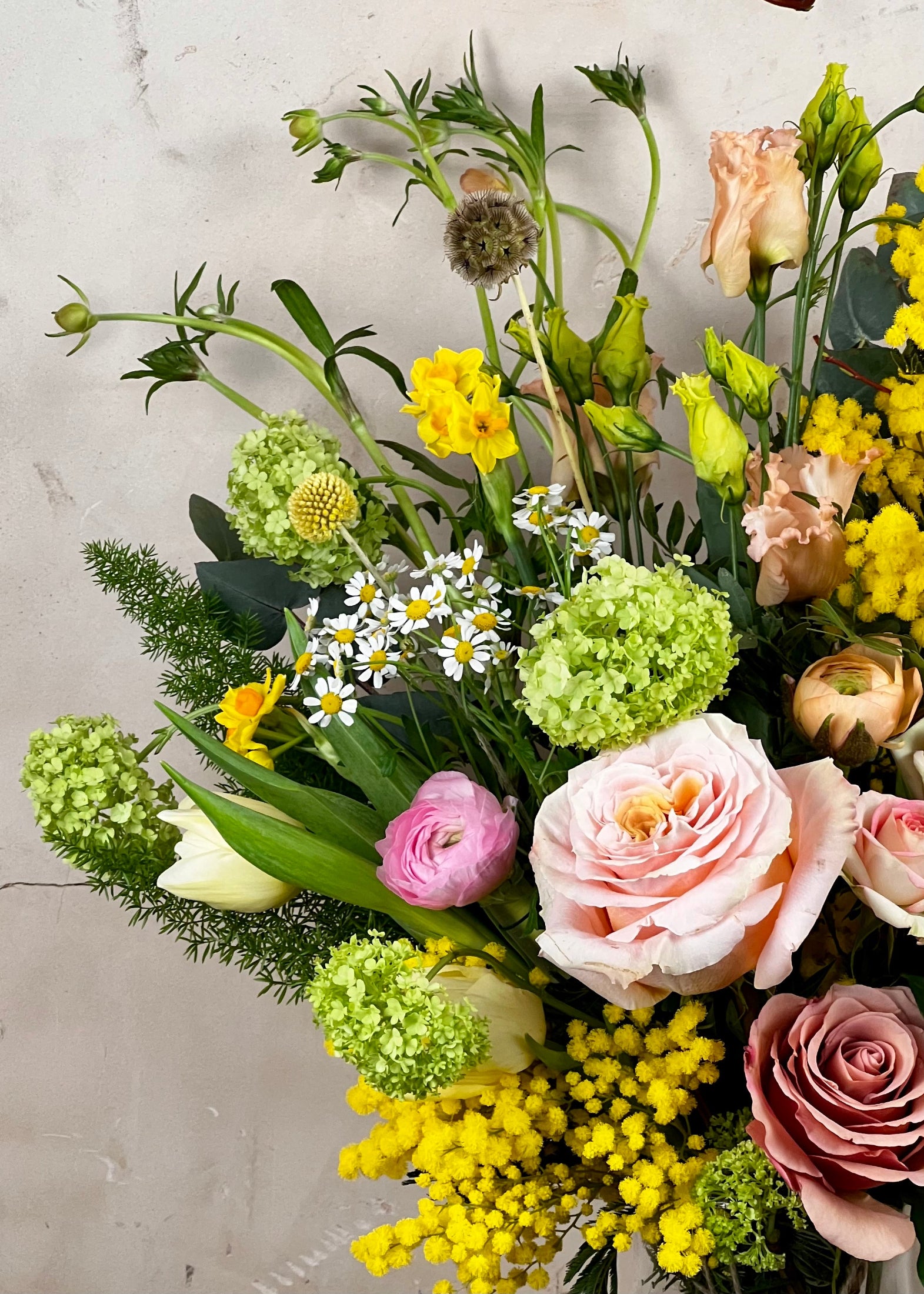 Bouquet of flowers with greenery on a light gray background