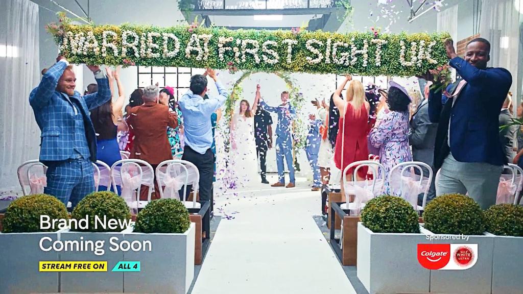 Event with 'Married at First Sight' sign made from flowers, people celebrating a wedding ceremony, and 'All 4' branding.
