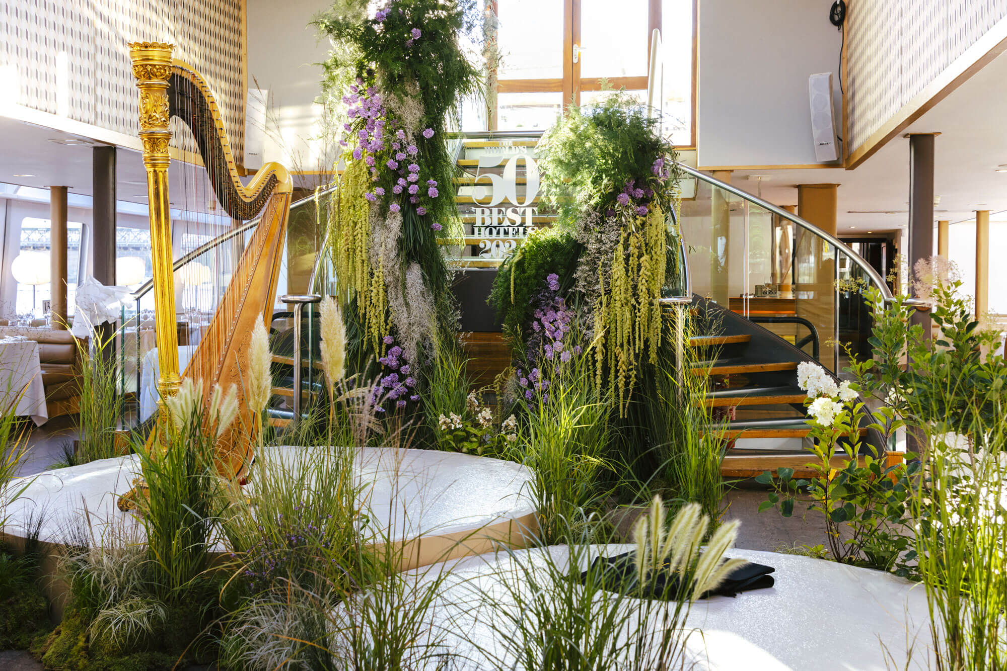 BLFS Large installation with floral sculpture and grass garden framing a stage