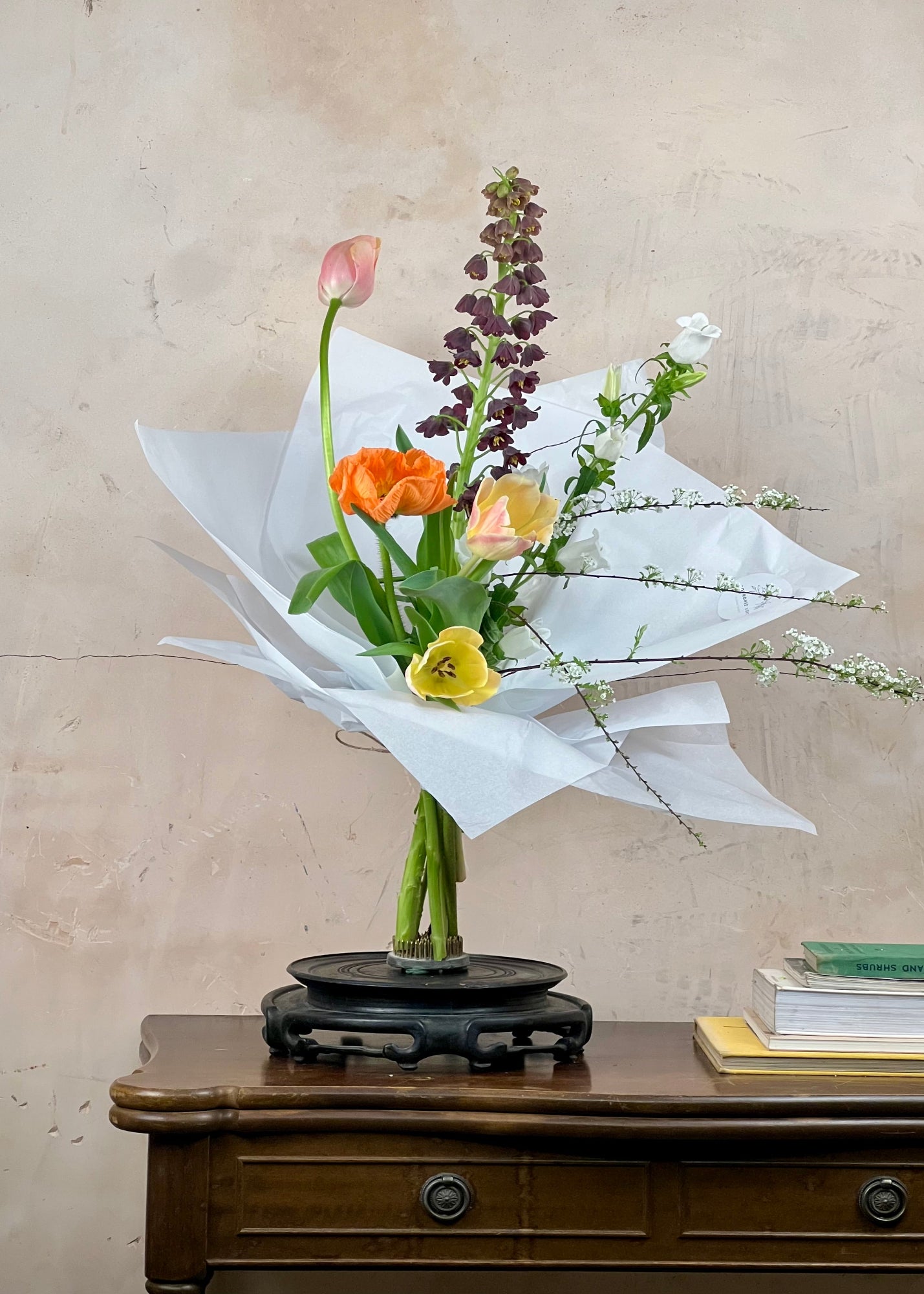 Bouquet of flowers on a wooden table with a beige background