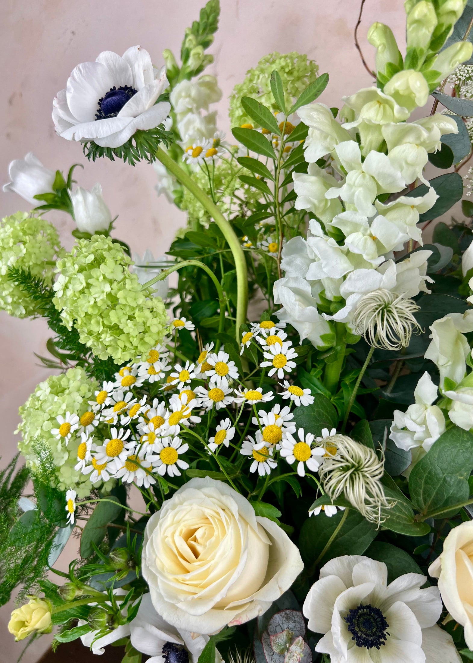 Bouquet of white and green flowers with a neutral background
