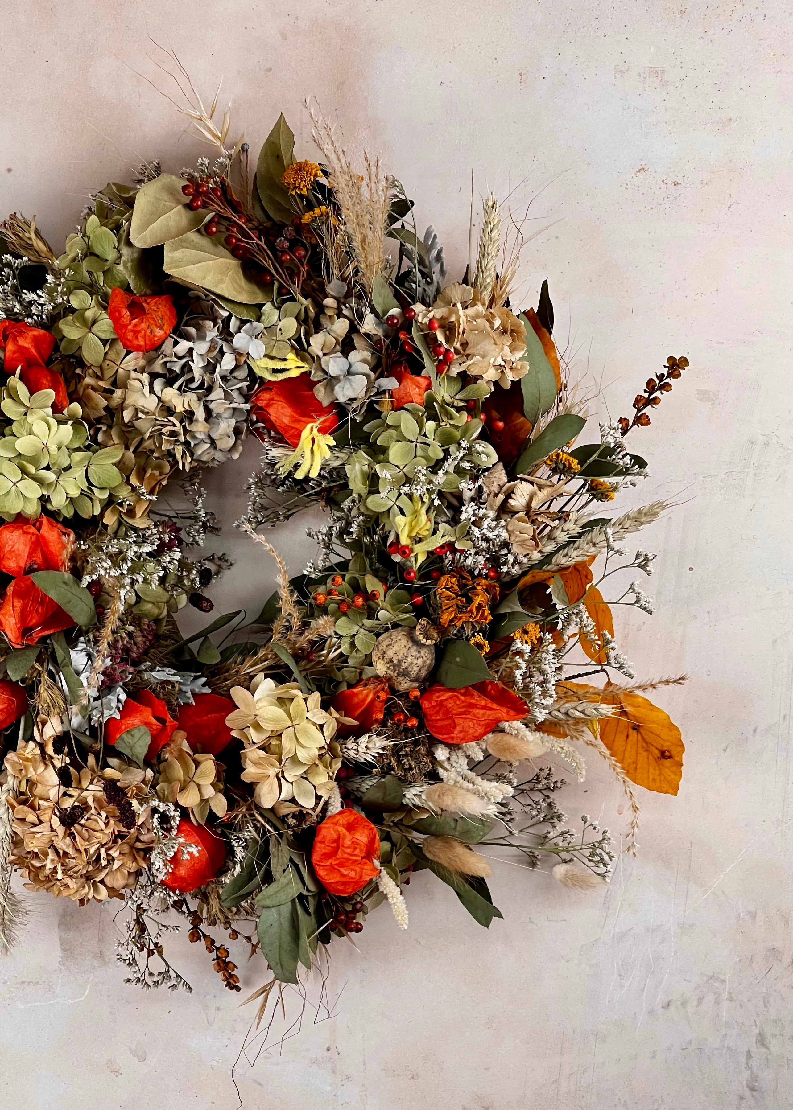 Decorative wreath with autumnal elements on a neutral background