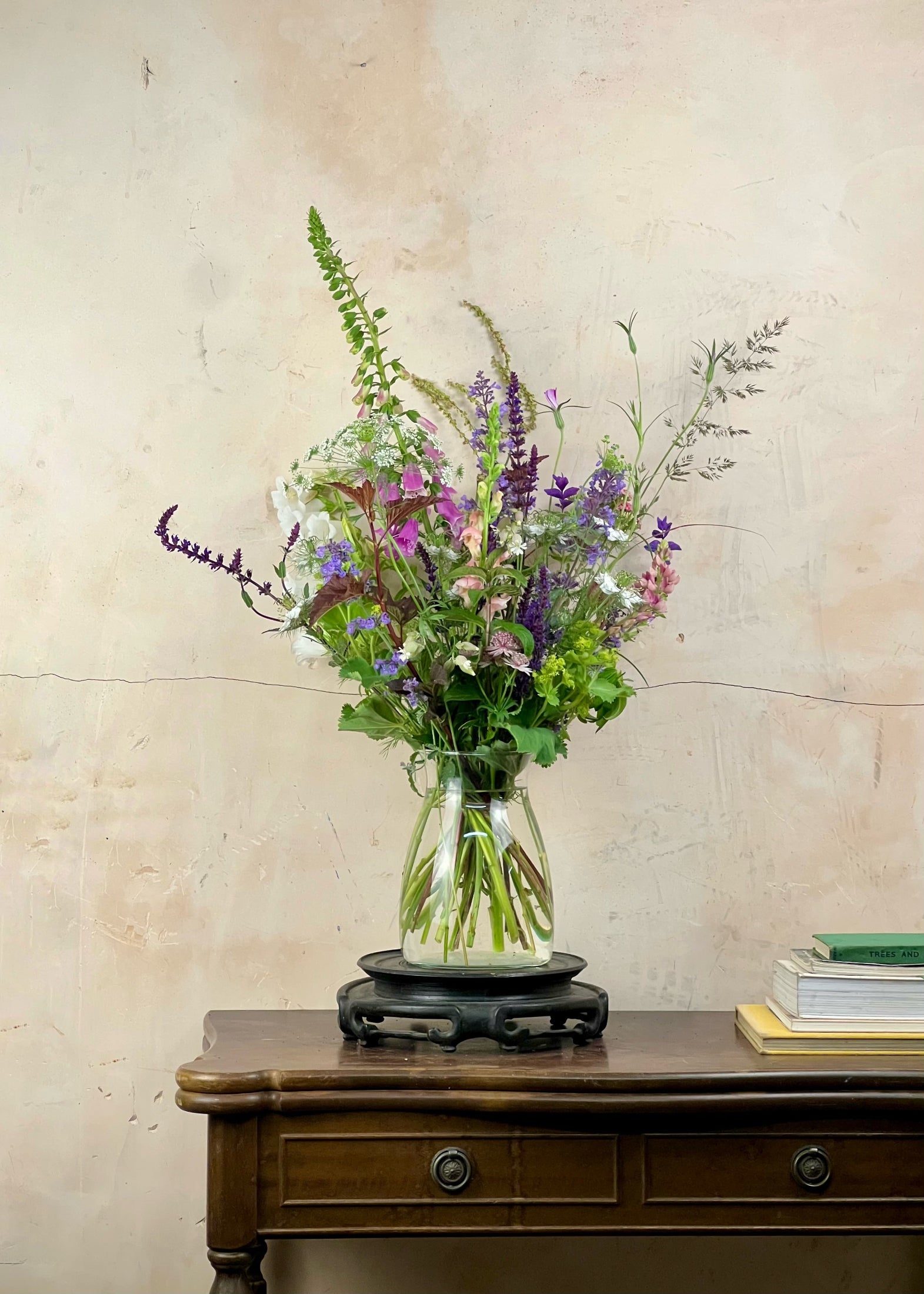 Bouquet of flowers in a vase on a wooden surface with a light background