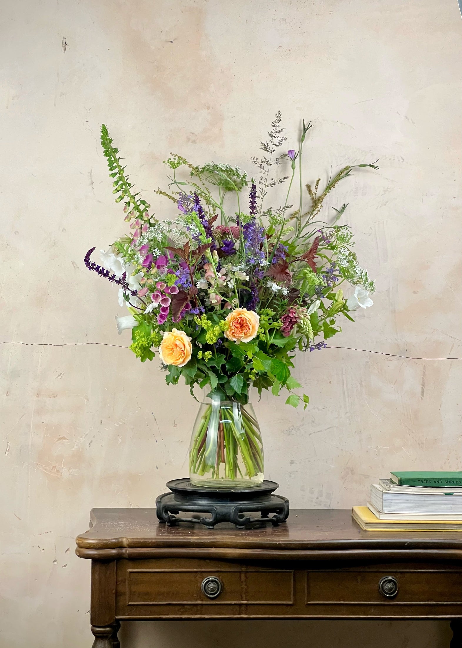 Bouquet of flowers in a vase on a wooden surface with a light background
