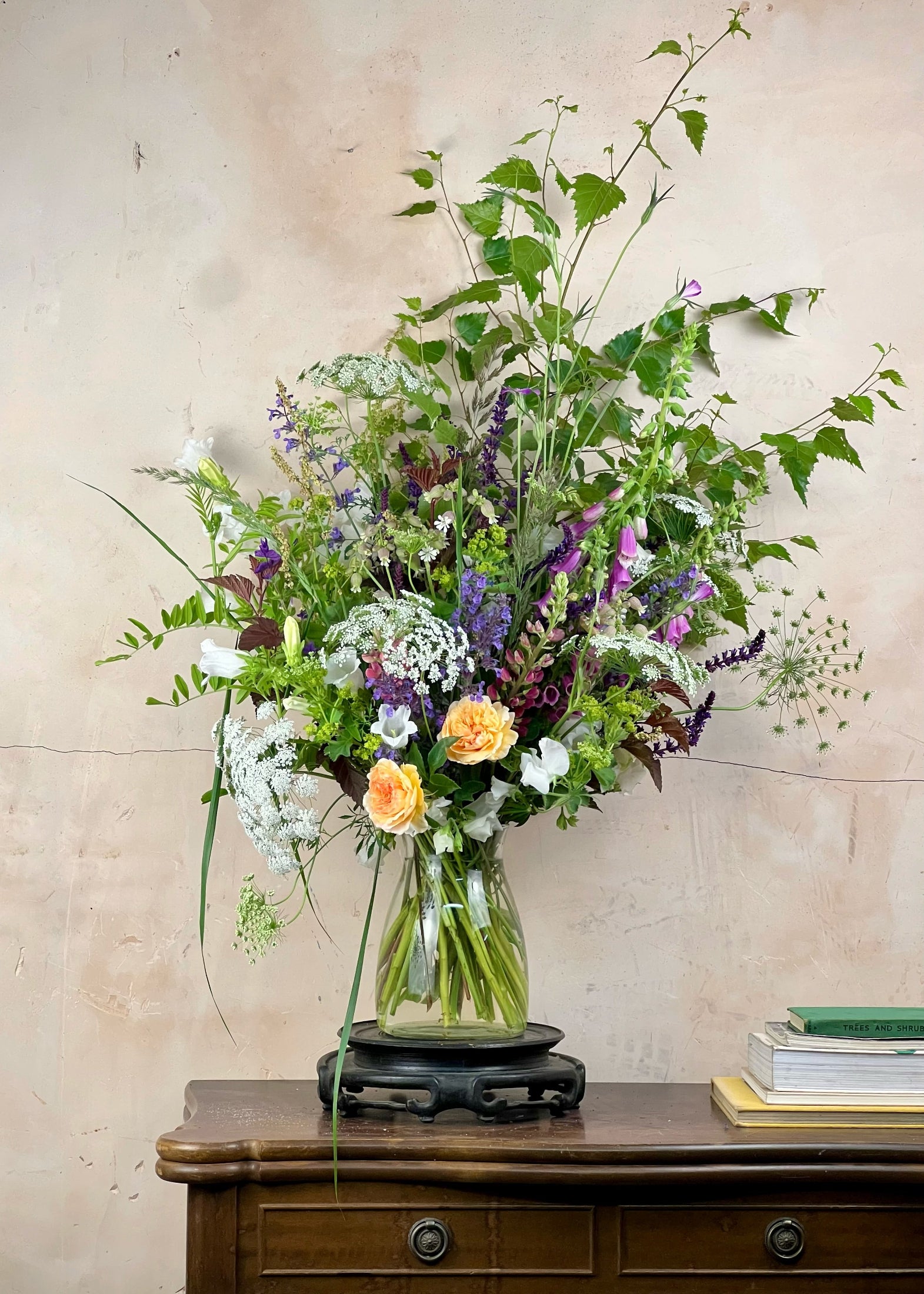 Bouquet of flowers in a vase on a wooden surface with a light background